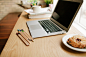 Laptop and baked good on a desk. by EasyPx on 500px