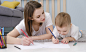 happy-little-child-boy-hand-drawing-pictures-with-mom (2)