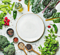 Fresh greens, raw vegetables and grains, white plate in center by Anna Ivanova on 500px