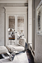 The mirrored closet doors in Joseph Dirend's Parisian apartment reflect the bed and an Azucena sconce.