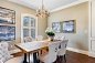 Large transitional medium tone wood floor and brown floor dining room photo in New Orleans with beige walls