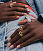 The model's hands are around her jean belt loop and she is wearing Pyra Chunky Rings in Gold Vermeil