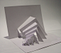 This may contain: an abstract white paper sculpture on top of a table