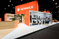 This may contain: an exhibit booth with orange and white signage on the wall that says ledvance