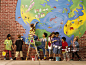 Children (5-7) painting an earth mural