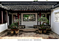 Traditional Chinese courtyard with decorative Bonsai plants and classical windows at Chinese Gardens, Singapore
