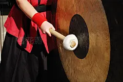 hand with stick and gong