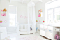 White crib with tulle canopy in pastel colored baby's room by Caia Images on 500px