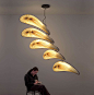 Nana 100 Mobile Light : The Nana 100 is a mobile hanging light fixture that pays homage to the kinetic artworks of Alexander Calder. Movement is driven by the invisible air currents in your surroundings. Its five feather-like shades twist gently in the br