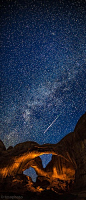 Perseid Meteor Streaking Over The Lightpainted Double Arch In Arches National Park - Utah