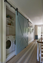 laundry room hidden behind blue barn door