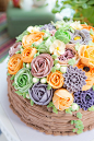 A birthday cake decorated with buttercream flowers