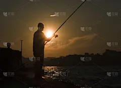 夕阳下抱鱼的剪影。
