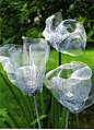 Ghost flowers made from window screen and tea lights -- These are made with upcycled window screen & tea lights  I want to make some for Halloween and paint them and put battery tea lights in them  You need old window or door screening, clear plastic