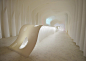 Kotaro Horiuchi creates a Paper Cave inside his architecture studio : Japanese architect Kotaro Horiuchi has created a white cave-like space in his office by hanging sheets of glass fibre paper from the ceiling.