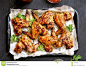 Baked chicken wings stock photo. Image of bowl, appetizer - 105513628 : Photo about Baked chicken wings on baking tray over dark stone background. Top view, flat lay - 105513628