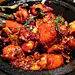  三杯鸡主料：三黄鸡仔一只(一斤多点)。 配料：小葱50克、姜25克、蒜25克 制作工艺： 1、将净鸡切成见方的大块； 2、把姜切片，葱切段，整粒蒜； 3、先放少许油（10克），将切好的主料、配料全部装入耐热的砂锅中，稍煎后，倒入三杯调味品（25克油）和冰糖，香叶放入后加盖以文火焖制，每隔十分钟左右翻动一次,以防糊底； 
4、大约炖烧半小时，待卤汁收浓，洒上香油，最后配以“罗勒”香草。 

调料：食用油一杯35克（原来用猪油）、米酒一杯60克、酱油一杯60克、香油15克、冰糖10克、香叶2片、鲜罗勒6片。