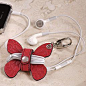 a stylish way to tame the earbuds. I like the idea behind it, but maybe something other than a butterfly.