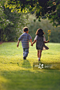 Rear view of boy and girl holding hands