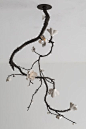 sculpture in bronze with illuminated white porcelain blossoms - david wiseman