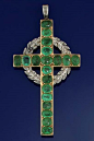 AN EDWARDIAN GOLD, EMERALD AND DIAMOND LATIN CROSS PENDANT. The cross set with oval-cut emeralds within a millegrain border, to a rose-cut diamond wreath and pendant loop, circa 1910.: 