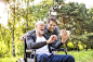 Hipster son and father in wheelchair at park taking selfie. by Jozef Polc on 500px