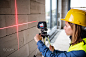 Young woman worker with laser on the building site. by Jozef Polc on 500px