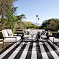 The huge stripe indoor/outdoor rug make this space the posh-est of outdoor patios.