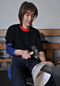 Silversmith Hiroshi Suzuki at work raising or forging a silver bowl.: 