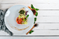 Fish fillet with spinach sauce and steam vegetables. Top view. On a wooden background. Copy space.