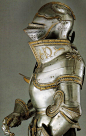 Gilded plate armor with armet helmet.