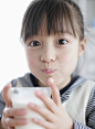 Japanese girl drinking milk with looking at camera