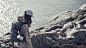 Girl walking on the rock side with Beosound Explore attached to the backpack