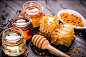 Honey in jar with honey dipper on black stone background by Cristina Perciuleac on 500px