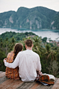 man and woman sitting on brown wooden platform