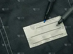 贴在工作服上写上主人的名字。一个干净的名称补丁的特写。姓名标签