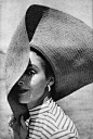 Model wearing a wide brimmed hat, 1950s.