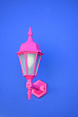 pink sconce on blue wall