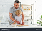 stock-photo-father-cutting-strawberry-by-knife-while-his-son-standing-near-at-kitchen-1126771208