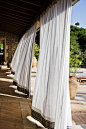 Outdoor curtains "A breeze blew through the room, blew curtains in at one end and out the other like pale flags, twisting them up toward the frosted wedding-cake of the ceiling, . . . " F. Scott Fitzgerald – The Great Gatsby (Chapter I):