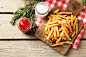 Tasty french fries on cutting board, on wooden table background :: Stock Photography Agency :: Pixel-Shot Studio