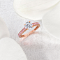 A Graff Flame Engagement Rings on a table with white petals