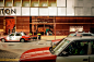 red and white taxi parked beside brown and white concrete structure