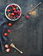 Berry frame with copy space on right. Strawberries, raspberries, blueberries and mint leaves, dark g by Anna Ivanova on 500px