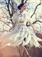 Posing outdoors, Vittoria Ceretti models Chanel top and skirt with frayed edges