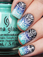 Tribal nail art design on top of a blue gradient theme. Dark and light blue are used for the gradient effect while white polish is used for the tribal designs on top.: