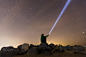 Silhouette of man with flashlight, wide stars and visible Milky way galaxy by Ivan Shilenko on 500px