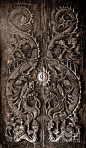 Antique wooden door, Sculpt a Dragon God. The age of approximately 200 years. In the ancient city of Songkla, Thailand