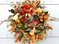 Crown your front door with berries, foliage, pinecones and other decorative touches that convey a warm fall welcome