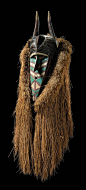 Africa | Anthropomorphic mask "banda" or "kumbaruba" from the Baga people of Guinea | Wood; white, turquoise and dark red paint.  Framed with a compact grass collar | ca. 1914.: